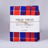 YOICHI Tartan 余市タータン 　播州織タータン生地　ラージチェック片面起毛加工の写真。赤、青、白で起毛のラージチェック生地で、白い帯と麻紐で包装されている。